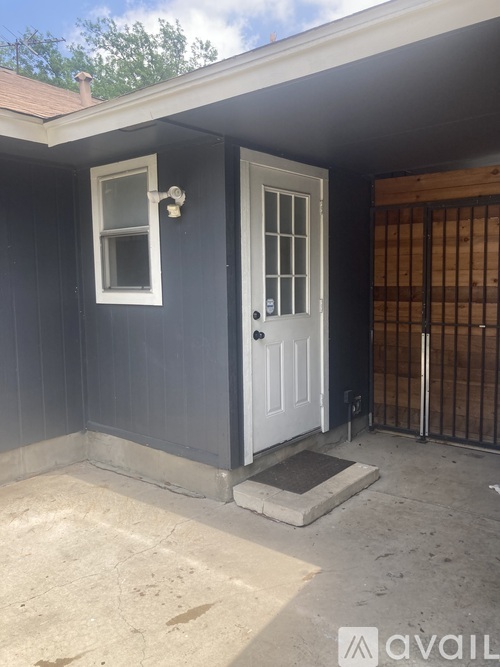 A small house with a white door and a window.