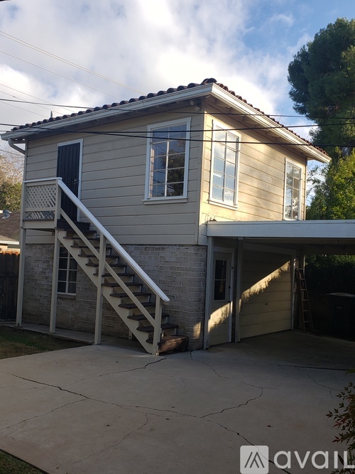 A house with a grey facade and a white garage door.