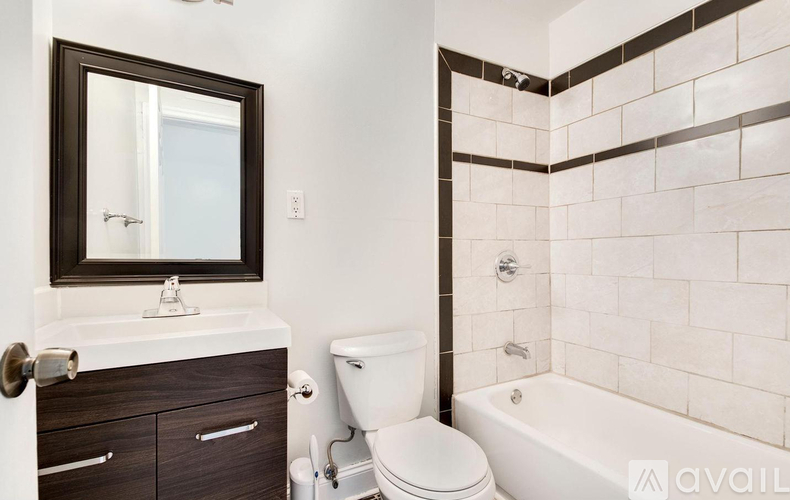 A bathroom with a white toilet, a white sink, and a bathtub.