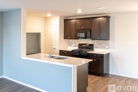 A kitchen with a blue wall and a white counter.