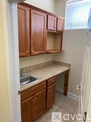 A kitchen with wooden cabinets and a sink.