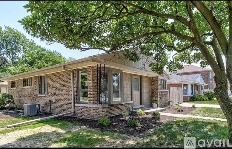A house with a tree in front of it.