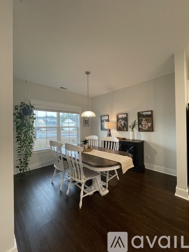 A dining room with a table and chairs.