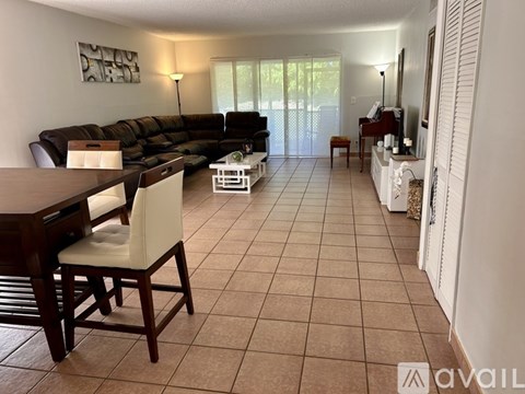 A living room with a brown table and a brown couch.