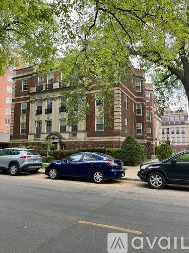 A blue car is parked on the side of the street.