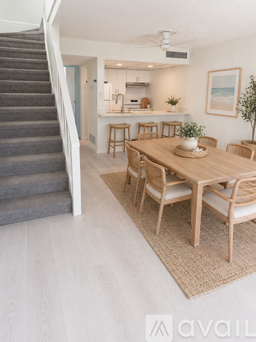 A dining room with a wooden table and chairs.