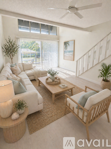 A living room with a white couch, wooden coffee table, and a ceiling fan.