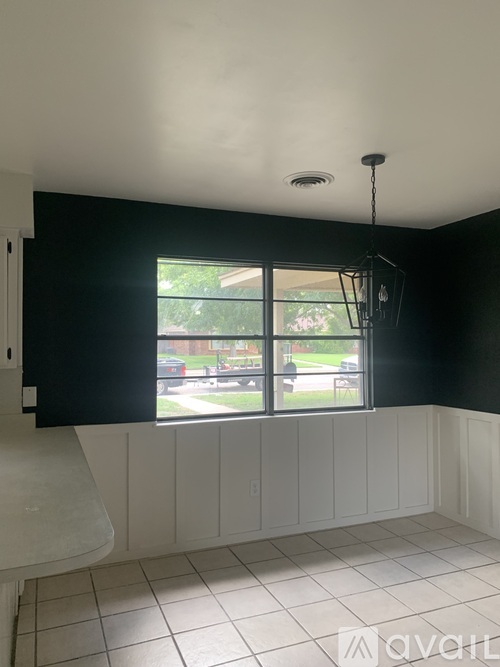 A room with a window and a shower.