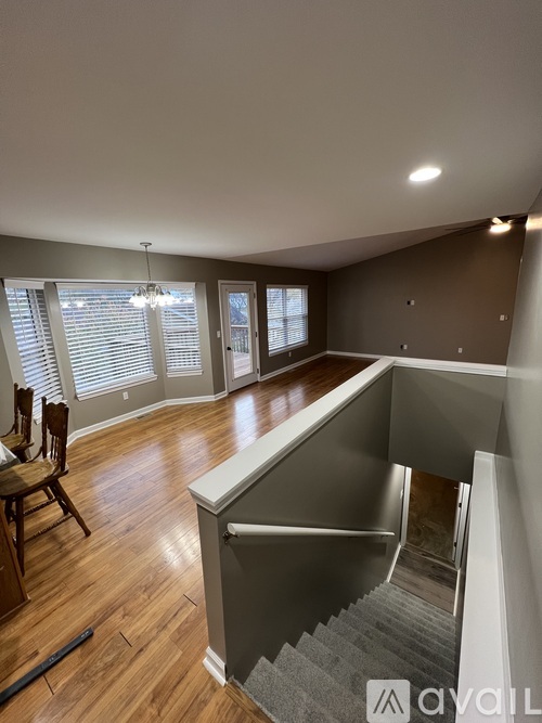 A living room with a staircase leading to the upper floor.
