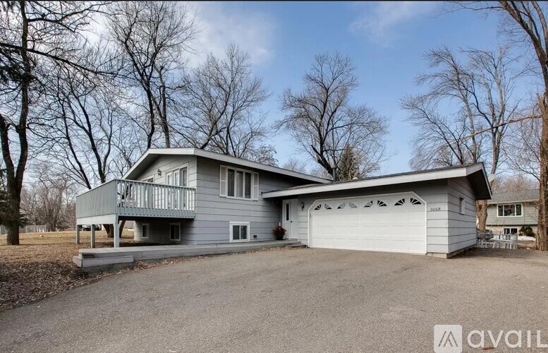 A two-story house with a garage is available for sale.