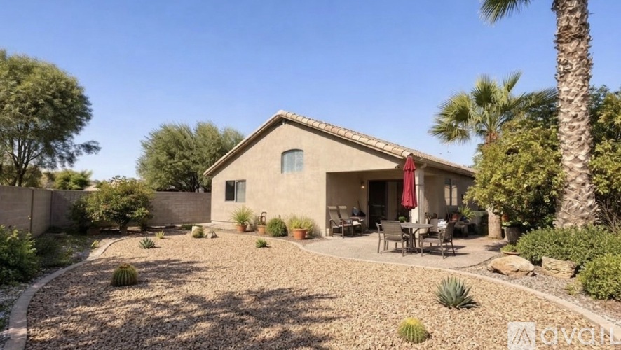 A house with a patio and a garden in front.
