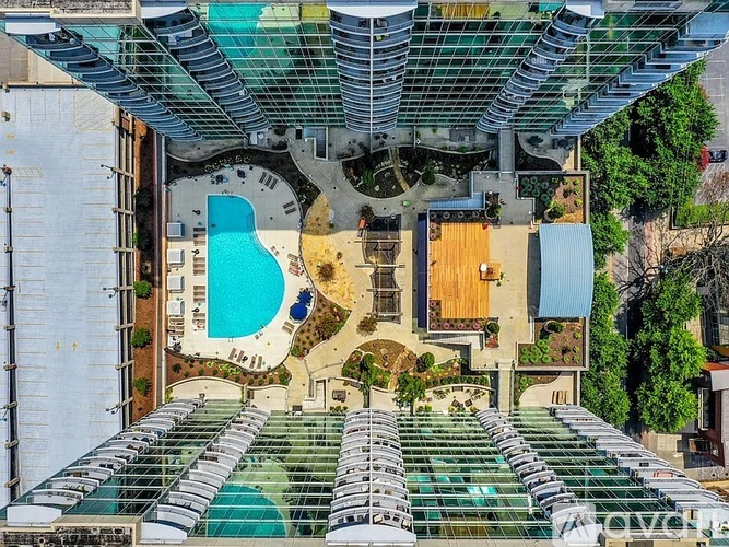 A large outdoor swimming pool surrounded by a glass ceiling.