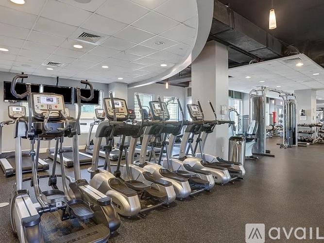 A gym with treadmills and elliptical machines.