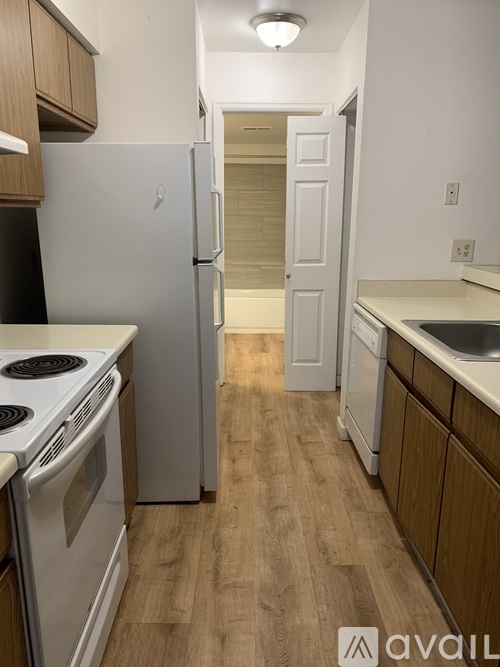 A kitchen with a white fridge and a white stove.
