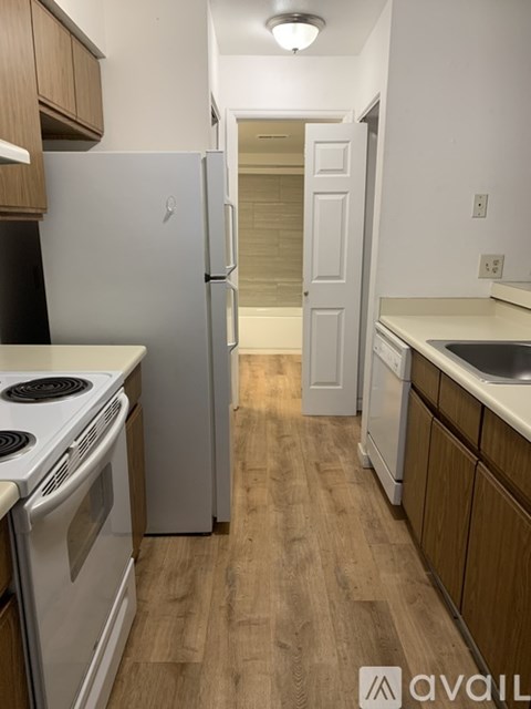 A kitchen with a white fridge and a white stove.