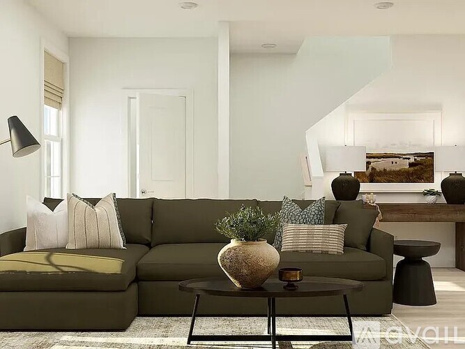 A living room with a green couch and a coffee table.