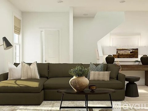 A living room with a green couch and a coffee table.