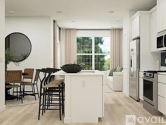 A modern kitchen with white cabinets and a large island.