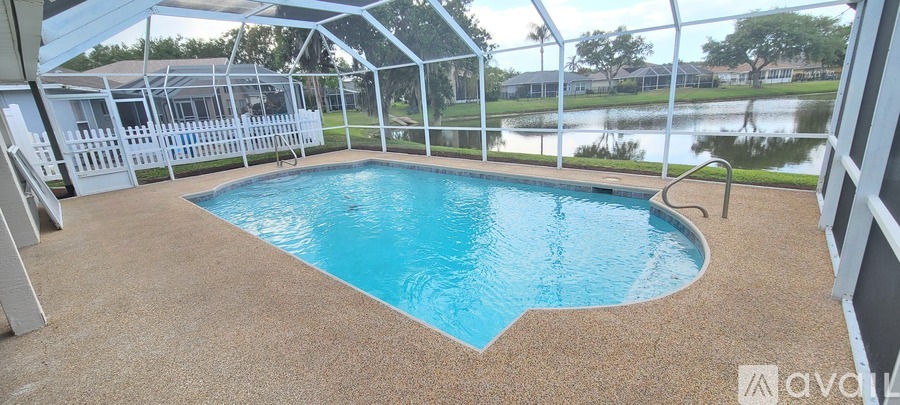 A small pool inside a house with a glass wall.