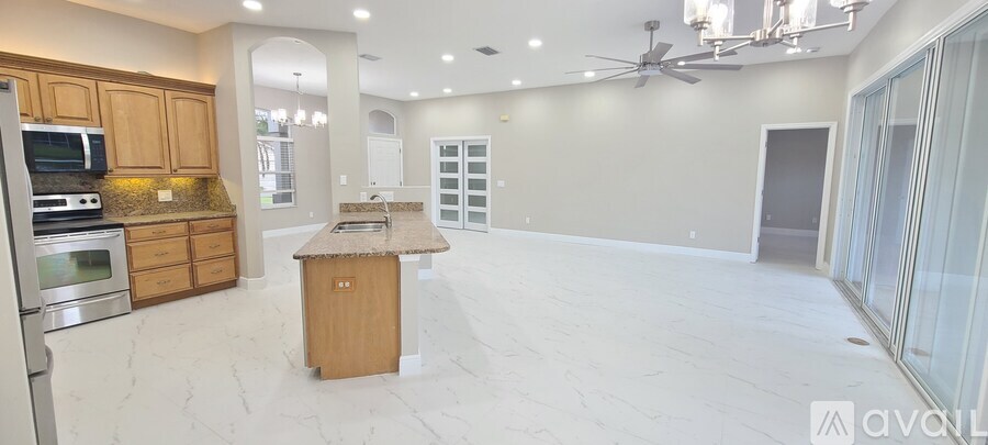 A kitchen with wooden cabinets and a marble countertop.