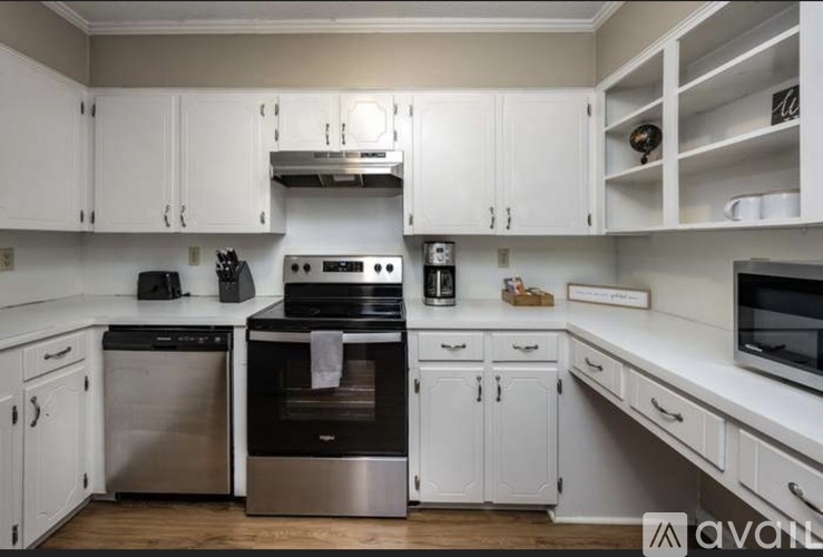 A kitchen with white cabinets and stainless steel appliances.