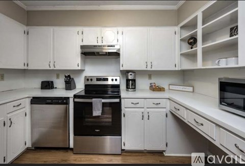 A kitchen with white cabinets and stainless steel appliances.