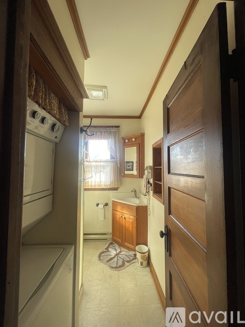 A kitchen with wooden cabinets and a white fridge.