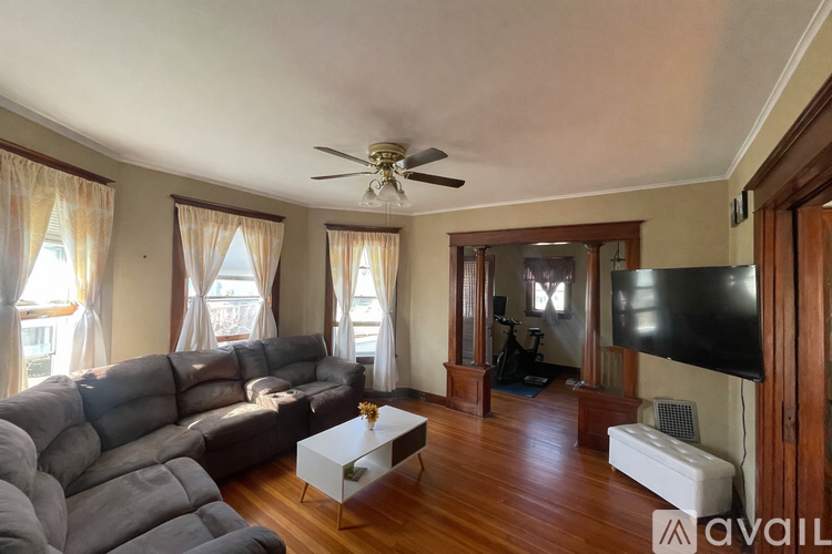 A living room with a grey sofa and a white coffee table.