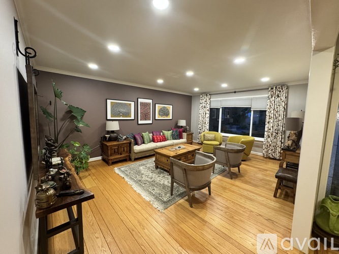 A living room with wooden floors and furniture.