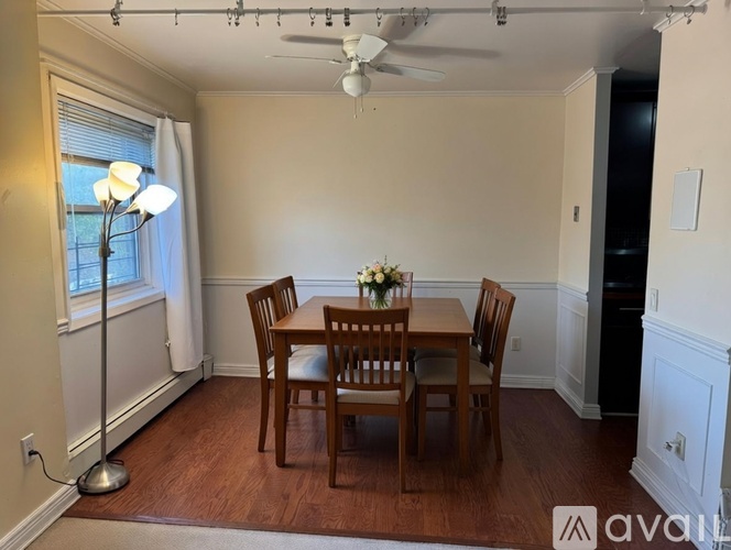 A dining room with a table set for two.