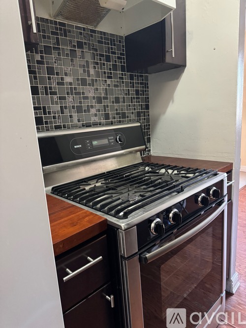 A modern kitchen with a stove and a microwave above it.