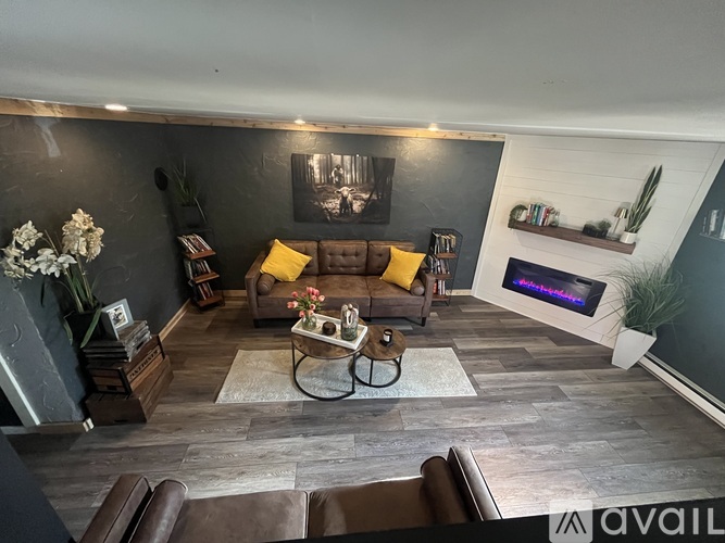 A living room with a brown leather couch and a coffee table.