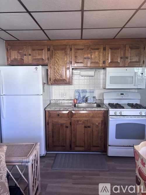 A kitchen with wooden cabinets and white appliances.