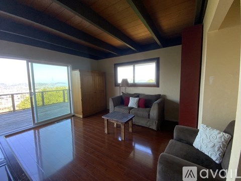 A living room with a grey couch and a wooden coffee table.