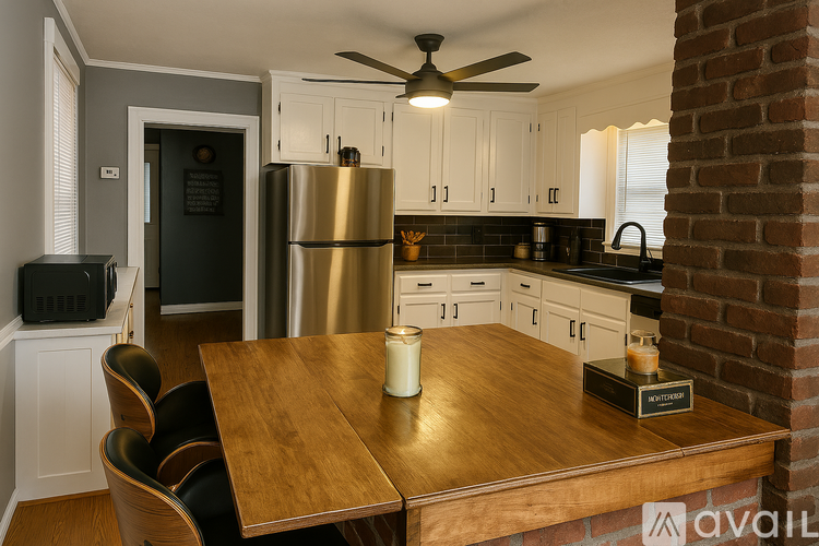 A kitchen with a wooden table and a brick column.
