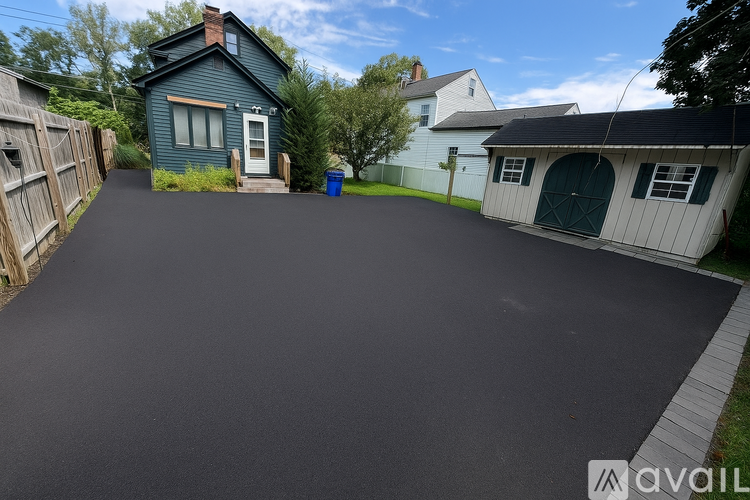 A blue house with a driveway in front of it.