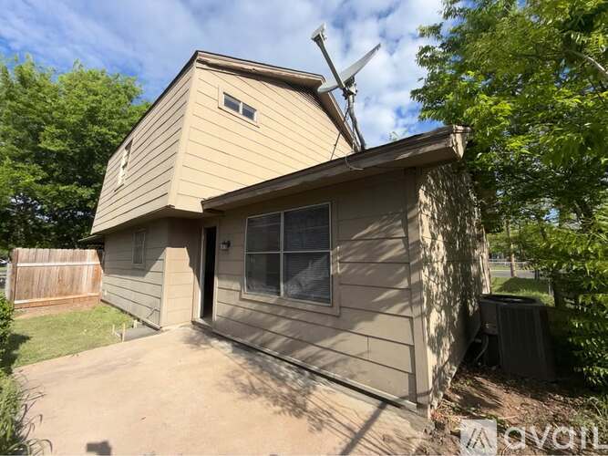 A house with a brown roof and a brown fence.