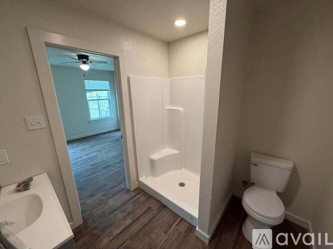 A bathroom with a toilet, sink, and bathtub.