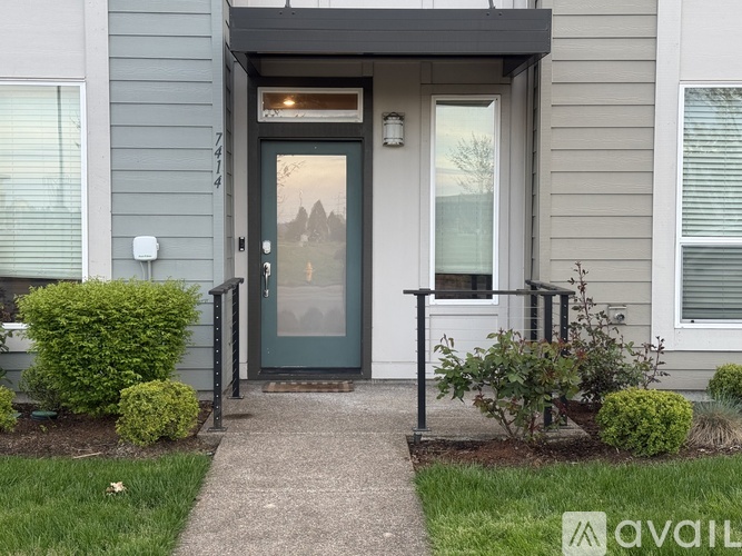 A house with a grey front and a black door.