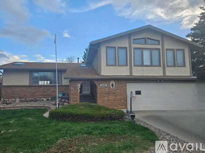 A house with a garage and a flag on the left side.