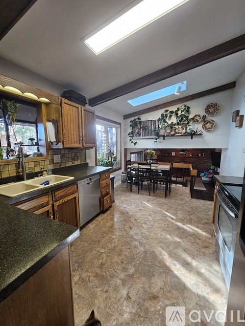 A kitchen with wooden cabinets and a large island.