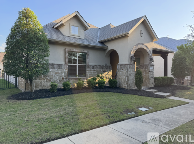 A house with a stone facade and a large front yard.