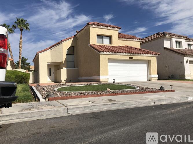 A house with a red tile roof and a white garage door is for sale.