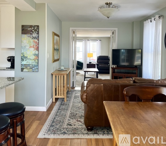 A dining room with a table and chairs.
