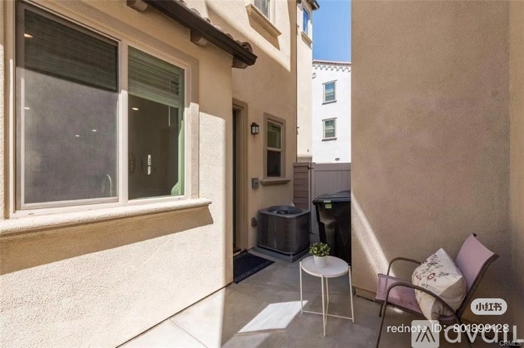 A small balcony with a table and chairs.
