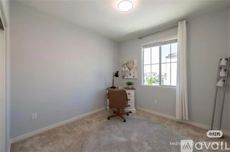 A room with a desk and a chair in it.