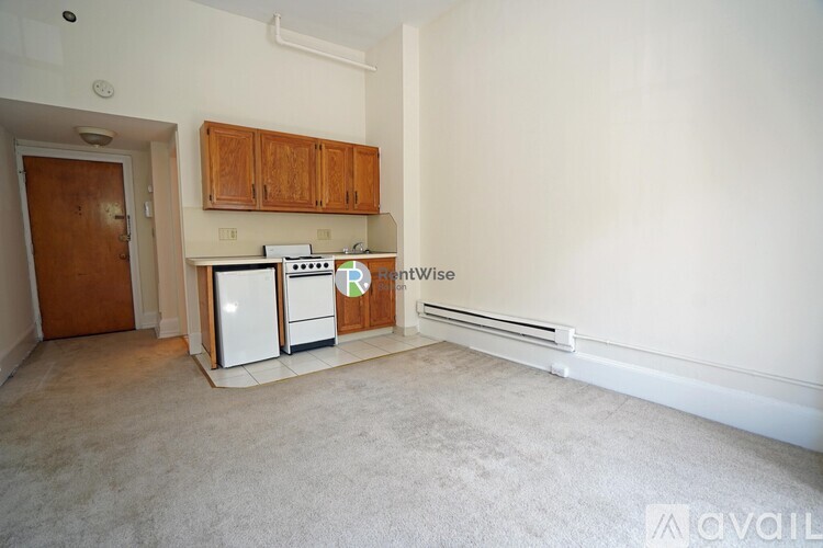A kitchen with white appliances and wooden cabinets.