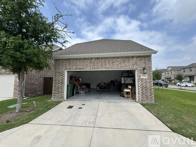 A detached garage with a brick exterior and a covered entrance.