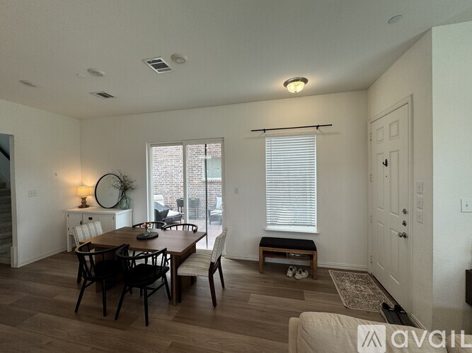 A dining room with a table set for four.