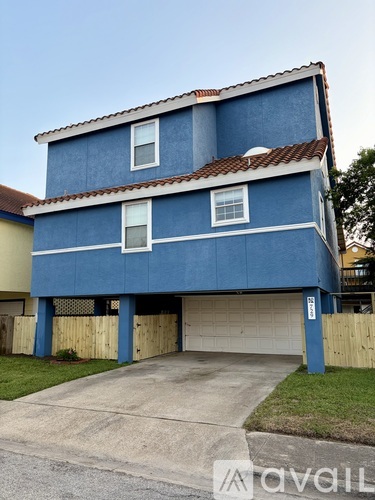 A two-story blue house with a garage.